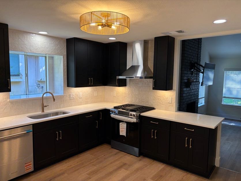 Kitchen remodel with black cabinets by Supreme Builders Group, remodeling contractor serving Hutto, TX